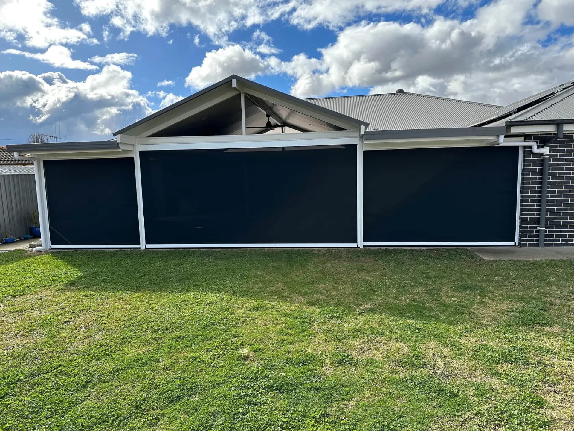 Full backyard view showing integrated zipscreen system