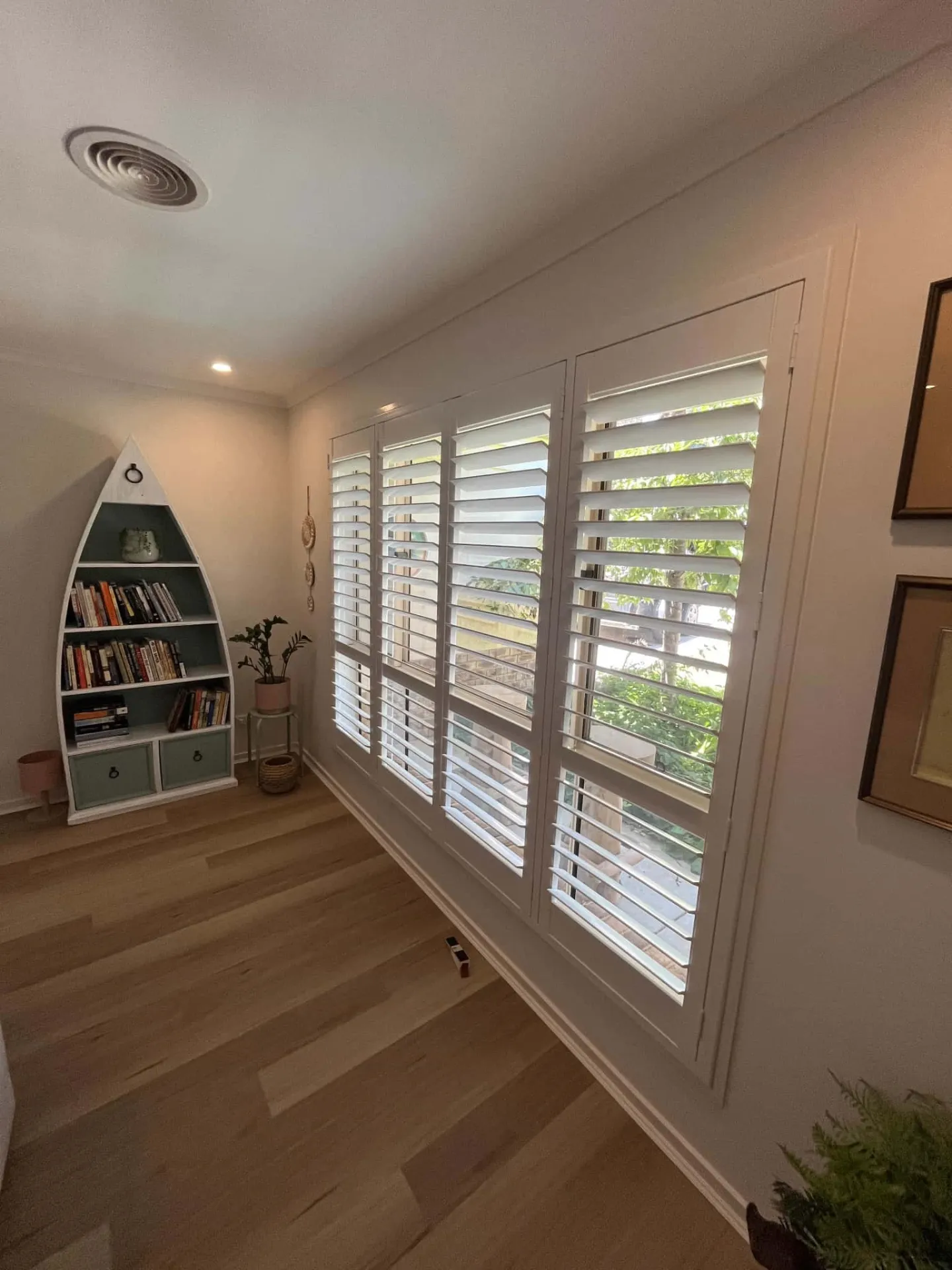 White PVC plantation shutters fitted in a Temora living room window