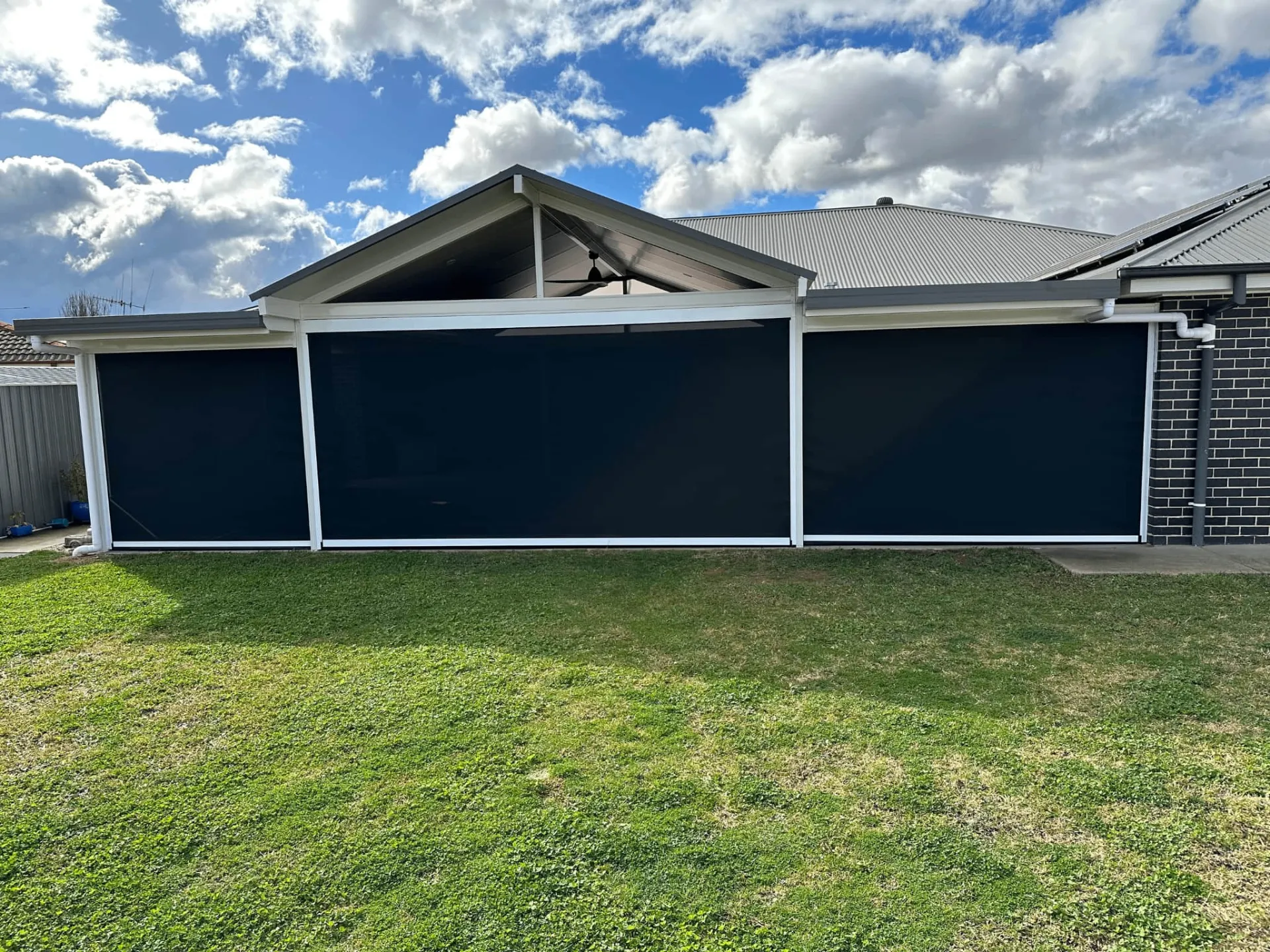 Full backyard view showing integrated zipscreen system