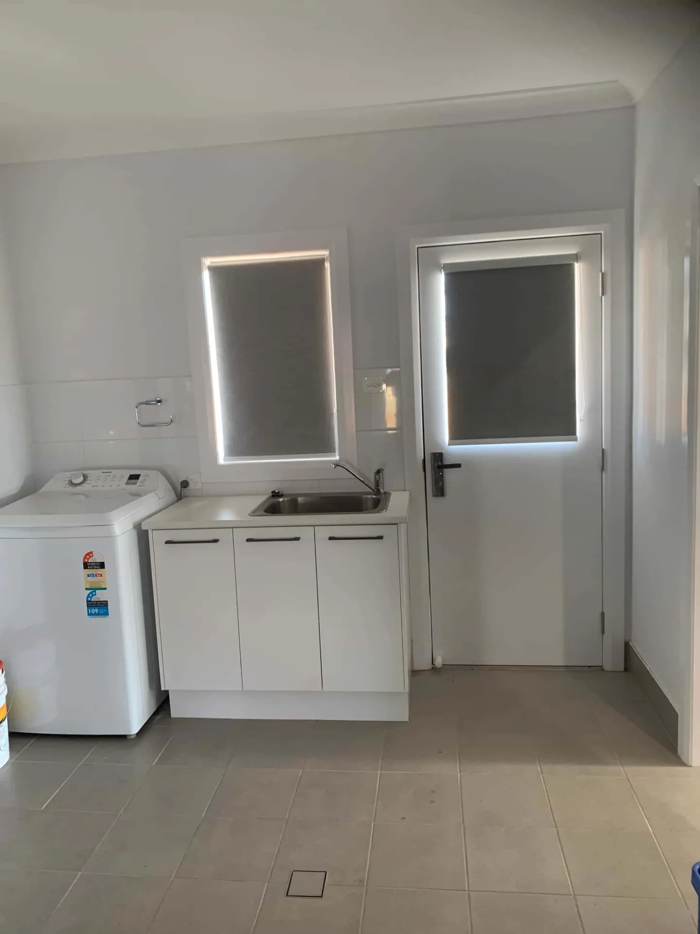 Roller blinds in laundry room for privacy and light control