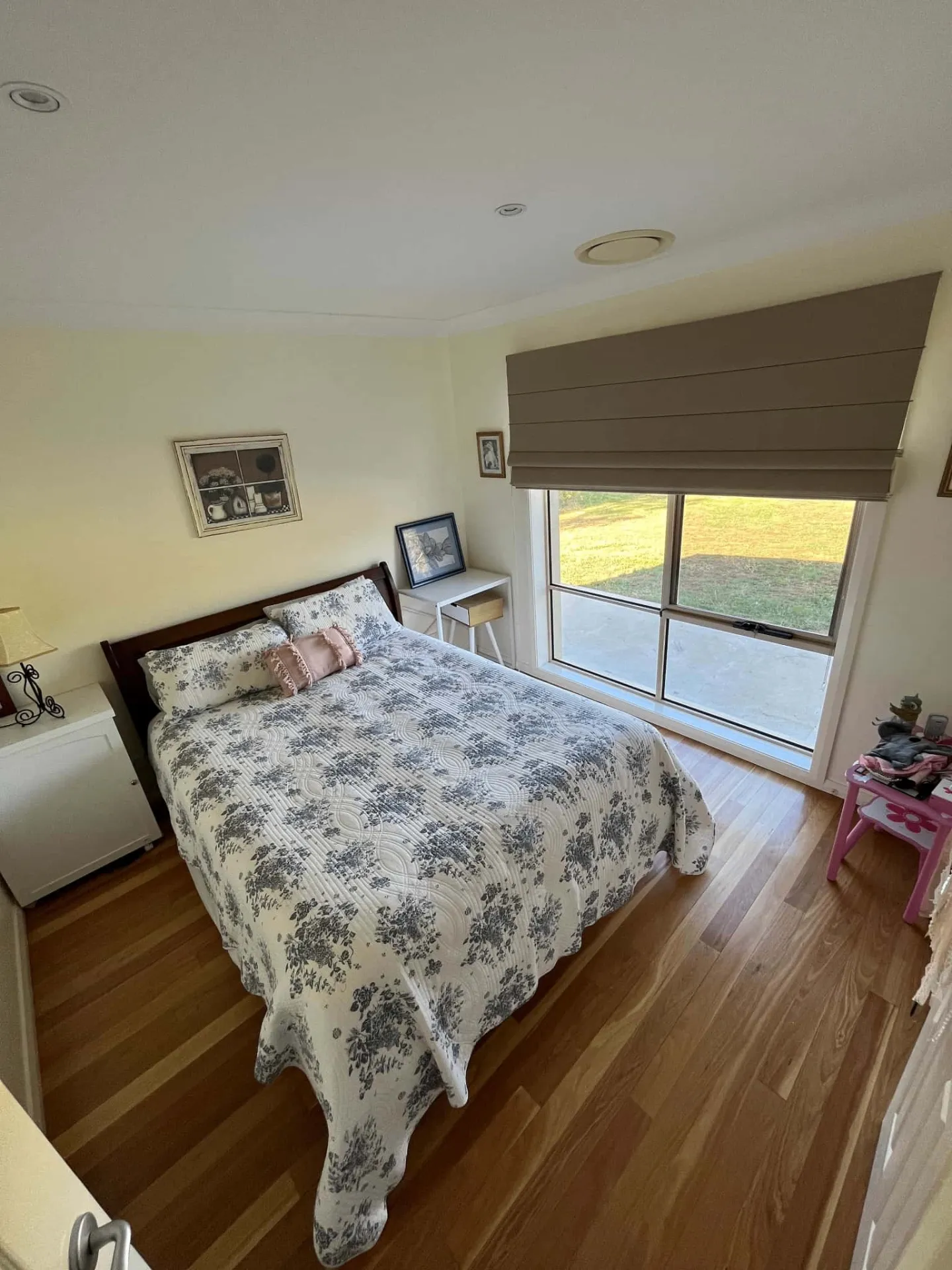 Roman blind in bedroom with warm timber flooring