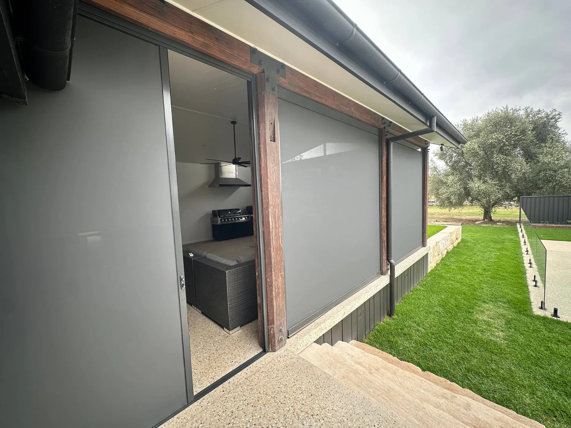 Outdoor entertaining area with zipscreens and timber posts